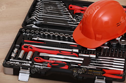 Preview: Toolbox, tools kit detail and orange protective helmet close up. instruments. set of tools. car