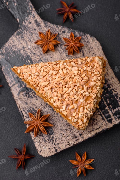 Preview: Delicious sweet puff waffle cake with cream and nuts cut into pieces