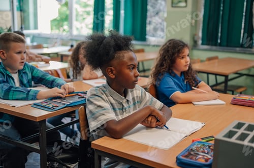Preview: Elementary school students listening attentively in classroom