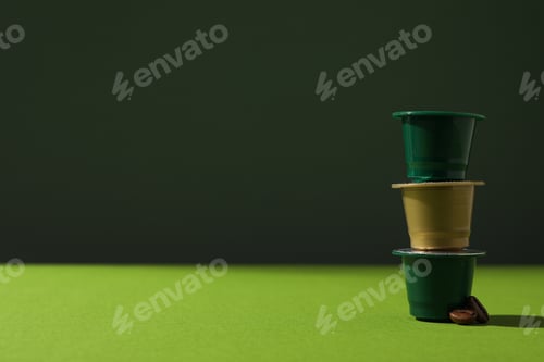 Preview: Green coffee capsules on green background, space for text