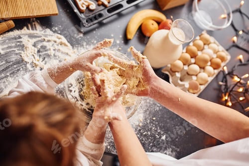 Preview: Close up view of brother with his little sister that preparing food on kitchen and have fun