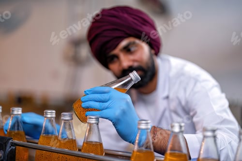 Preview: Beverage worker in drink factory stand working near drinking bottle conveyor production line