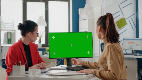 Preview: People doing teamwork with green screen on monitor
