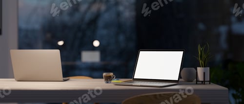 Preview: Modern co-working space in office at night with two laptop computer