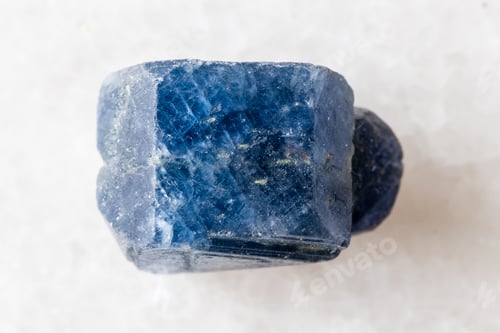 Preview: sample of rough blue sapphire crystal on white