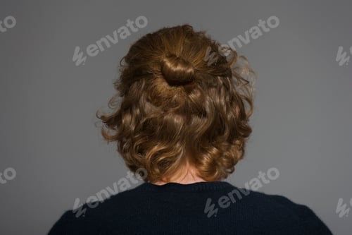 Preview: Back view of young man with bun