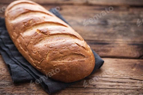 Preview: Fresh bread on wooden table. Top view with space for your text