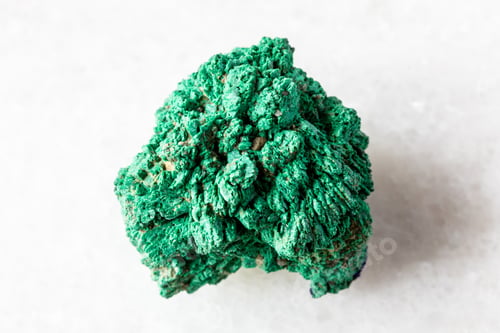 Preview: raw crystalline malachite mineral on white marble