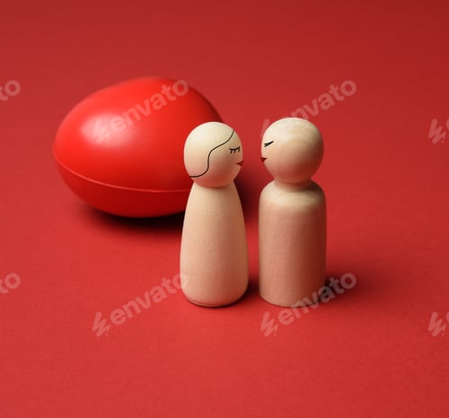 Preview: Two wooden figures on a red heart background
