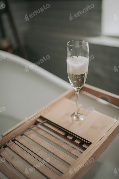 Preview: Luxury interior eco style modern bathroom with oval bathtub and champagne glass at natural lighting