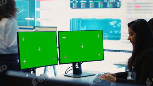 Preview: Executive officer analyzing greenscreen on monitors at his workstation