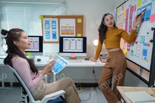 Preview: Two female ux ui designers are discussing user experience and user interface design for mobile appli