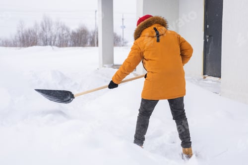 Preview: Man is clearing the snow near house and on staircases hovelling at the winter season. Winter storm