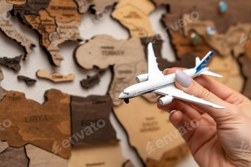 Preview: The white model plane against a wooden map. Travel concept