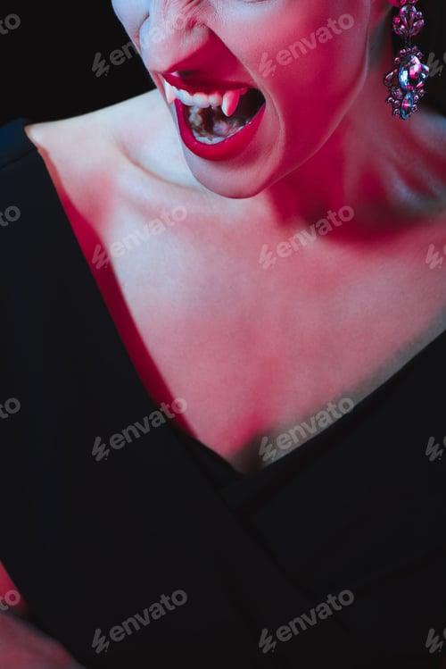 Preview: cropped view of vampire showing her fangs on dark background