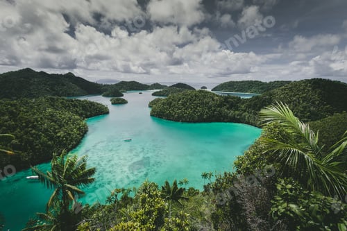 Preview: Landscape of the Wajag Island surrounded by the sea under a cloudy sky in Indonesia