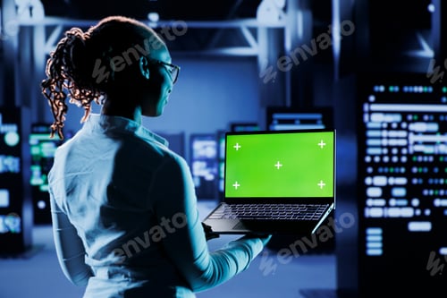 Preview: Developer codes on green screen laptop