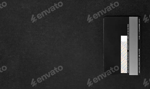 Preview: Overhead view of black credit card on dark background. Copy space.