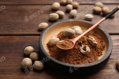 Preview: Nutmeg powder and seeds on wooden table