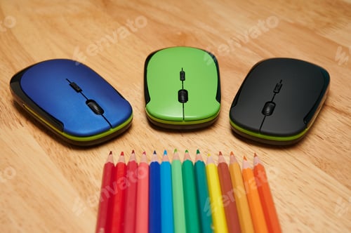 Preview: Closeup shot of multi-colored pencils and computer mouses on a wooden table
