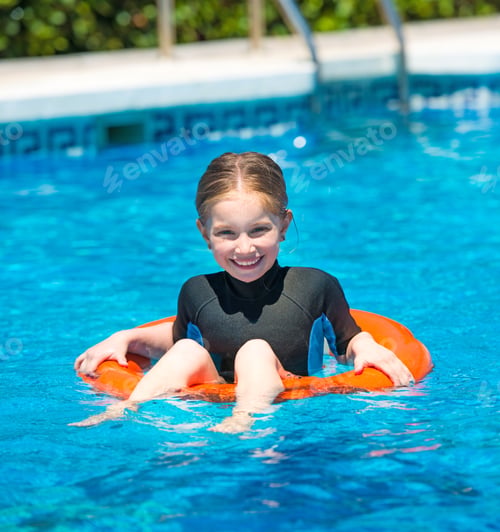Preview: happy little girl in a wetsuit