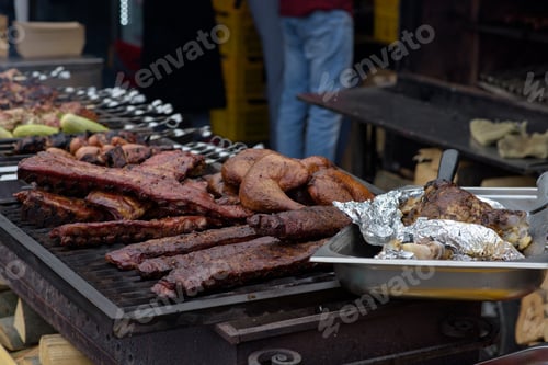 Preview: Grilled pork baby ribs with barbecue sauce on the grill. Festival street food