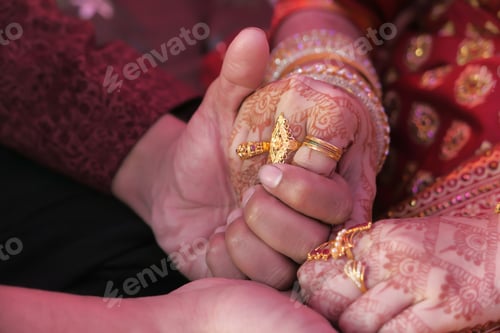 Preview: indian bride and groom holding hands at wedding day