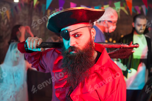 Preview: Side view portrait of handsome bearded man in a pirate costume at halloween celebration