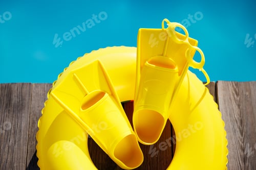 Preview: Fippers and goggles on wooden planks near swimming pool