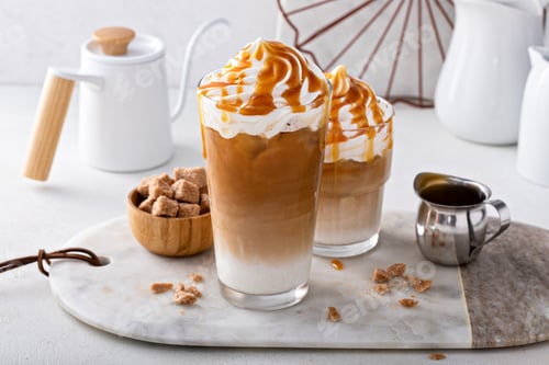 Preview: Iced caramel latte topped with whipped cream and caramel sauce