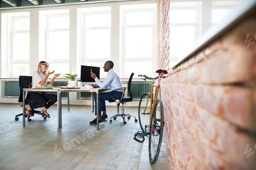Preview: Colleagues in start-up company, sitting in office, discussing