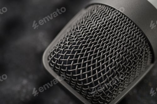 Preview: Gray studio condenser microphone on black soft foam of protective case. Macro shot