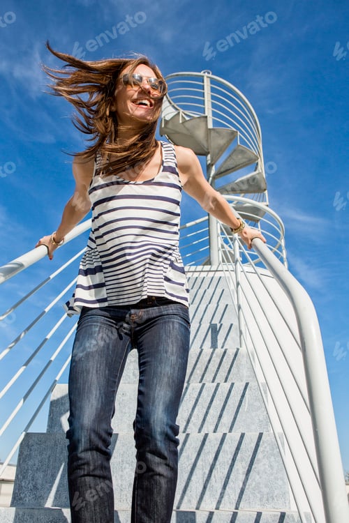 Preview: Candid portrait of mid adult woman on spiral staircase