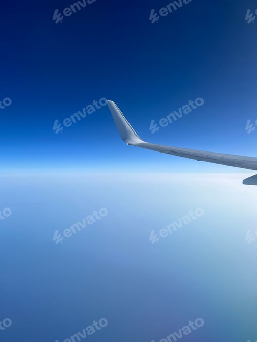 Preview: View from the airplane window. Beautiful cloudscape with blue sky.
