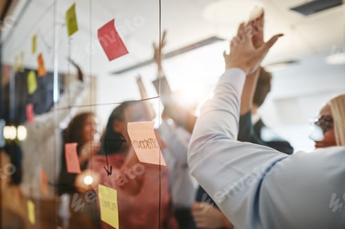 Preview: Diverse businesspeople high fiving after brainstorming together in an office
