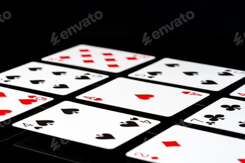 Preview: Playing cards on black background studio shot