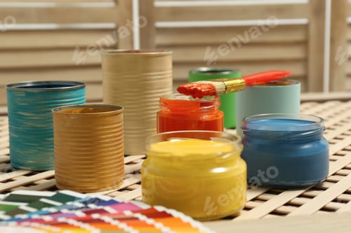 Preview: Different paints with brush and palette on wooden background