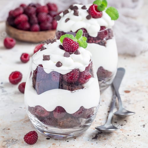 Preview: Trifle dessert with brownie, cream cheese frosting and raspberry in glass, square format