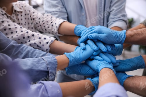 Preview: Group of people in blue medical gloves stacking hands indoors, closeup