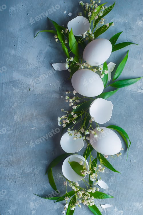 Preview: Overhead Easter background with white eggs, decorative green leaves and spring flowers. Organic