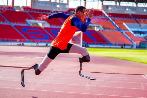 Preview: Asian para-athletes with prosthetic blades sprint on a running track at stadium.