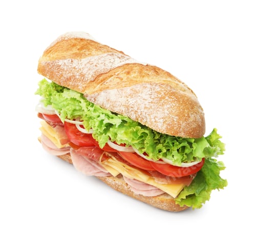 Preview: Tasty baguette sandwich with ham and vegetables isolated on white