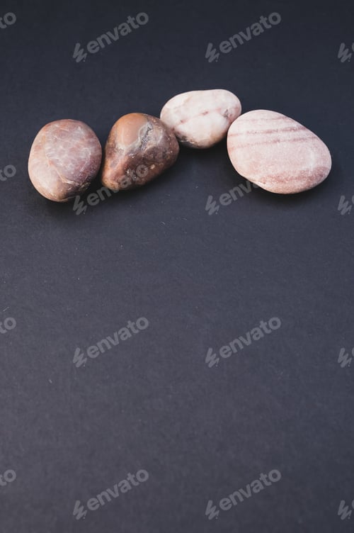 Preview: Vertical shot of pebbles isolated on a black background