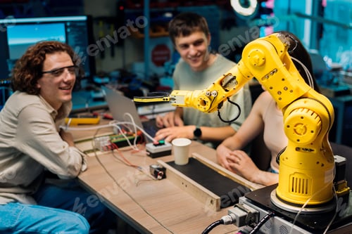 Preview: Group of young people doing experiments in robotics in a laboratory