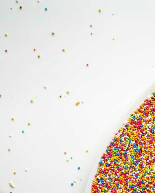Preview: top view of colourful sprinkles on white background