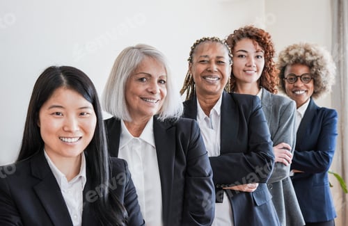 Preview: Multiracial business women smiling on camera inside modern office