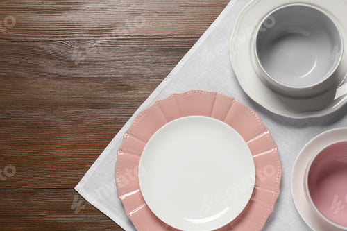 Preview: Beautiful ceramic dishware on wooden table, top view. Space for text