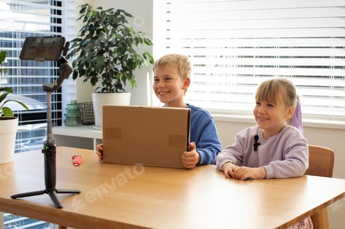 Preview: Kids recording an unboxing video for their vlog, smiling and excited as they reveal the contents