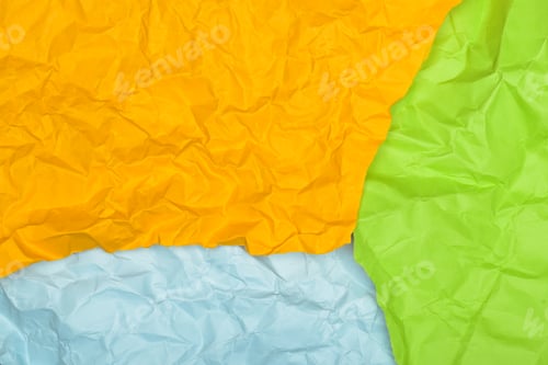 Preview: Crumpled sheets of yellow, light blue, and green paper arranged in an abstract composition.
