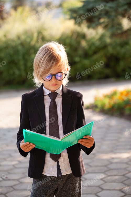 Preview: Pupil of Fashionable Schoolboy with a book and glasses, school uniform.